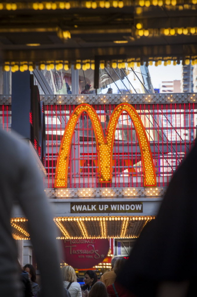 Pedestrians pass a McDonald’s restaurant in Times Square in New York.   Bloomberg