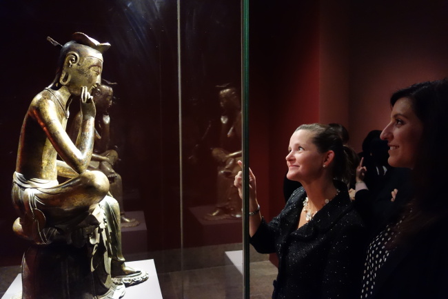 Visitors look at exhibited items at the opening reception of “Silla: Korea’s Golden Kingdom” at the Metropolitan Museum of Art in New York on Monday.   National Museum of Korea