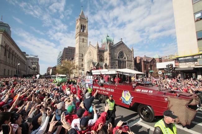 Duck boats make their way down Boylston Street, where fans gathered for the World Series victory parade for the Boston Red Sox in Boston, Massachusetts, Saturday.     AFP-Yonhap News