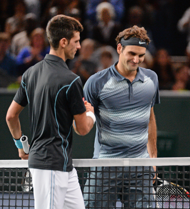 Novak Djokovic shakes hands with Roger Federer after winning the semifinal of the Paris Masters on Saturday.   AP-Yonhap News