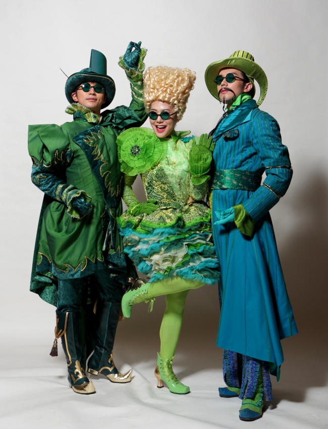 Actors and an actress pose for a photo in costumes created for the upcoming run of “Wicked.”   Seol & Company