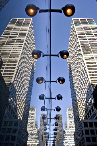 The headquarters of Blackstone Group LP (right) is reflected in the glass facade of the Doubletree Hotel in New York.   Bloomberg