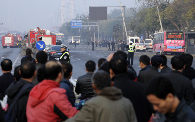 Residents gather near the site of multiple explosions outside the provincial headquarters of China’s ruling Communist Party in Taiyuan in north China’s Shanxi province on Wednesday.   AP-Yonhap News