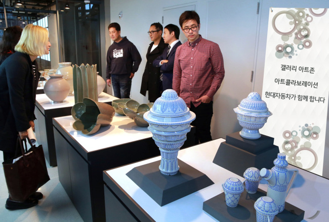 Visitors look at artworks displayed at the Gallery Art Zone in the National Museum of Modern and Contemporary Art.   Hyundai Motors