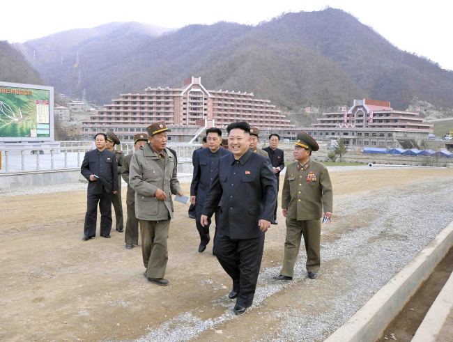North Korean leader Kim Jong-un talks with officials at a ski resort under construction at the Masik Pass on Nov. 2.   Yonhap News