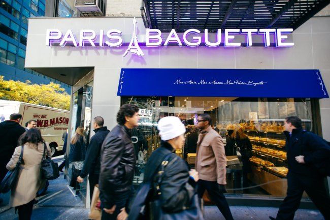 People walk past Paris Baguette’s Manhattan outlet in New York.   SPC Group