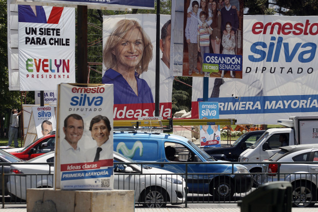 A street corner is filled with election campaign signs, including presidential candidate Evelyn Matthei (center left), in Santiago on Saturday.   AP-Yonhap News