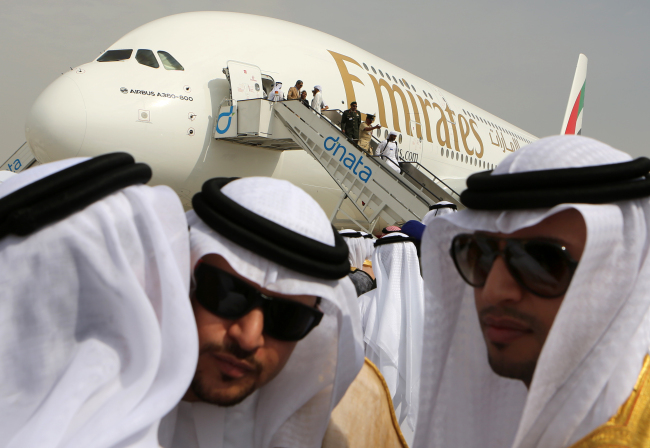 Emirati officials greet each other in front of an Emirates Airbus A380 on display during the opening day of the Dubai Airshow in Dubai, United Arab Emirates, Sunday.   AP-Yonhap News