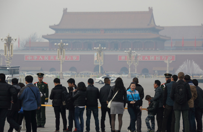 People wait in line for Tiananmen Square to open in Beijing.   Bloomberg