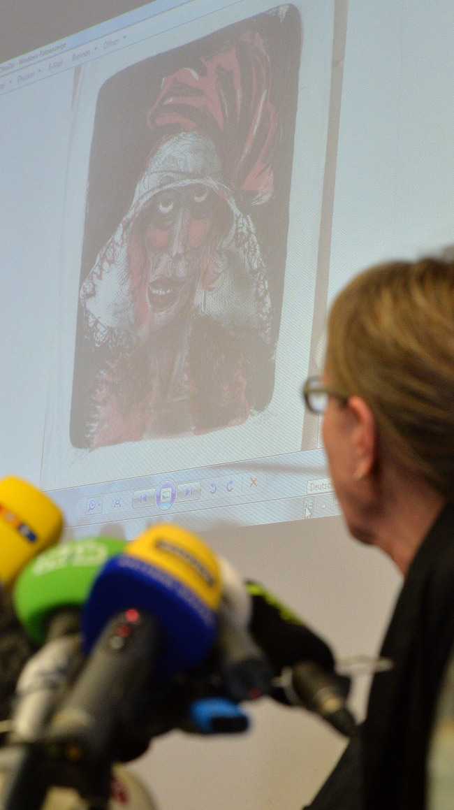 Art historian Meike Hoffmann from the Berlin Free University looks at a projected painting of Otto Dix during a news conference on the art found in Munich, in Augsburg, southern Germany, Nov. 5.    AP-Yonhap News