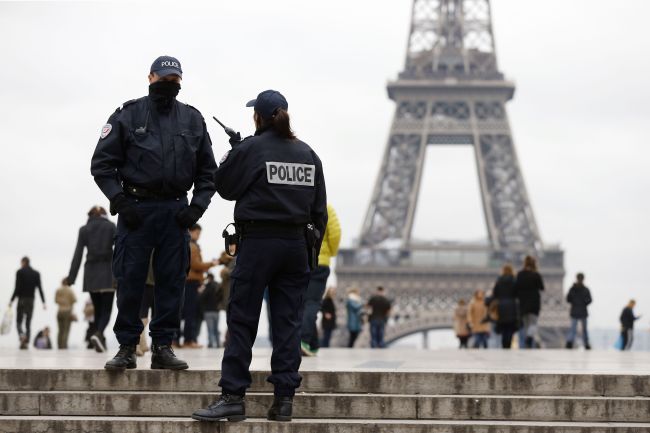 Police officers patrol at the Trocadero Esplanade in front of the Eiffel Tower in Paris on Monday.   AFP-Yonhap News