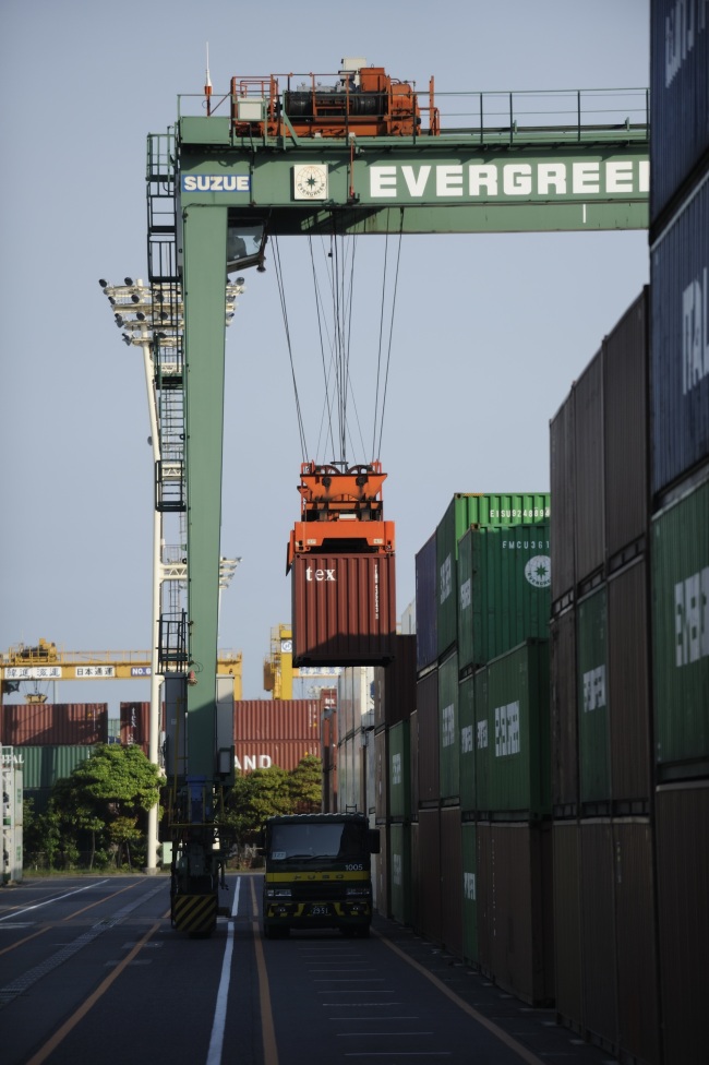 A container is loaded onto a truck at a shipping terminal in Tokyo on Wednesday.   Bloomberg