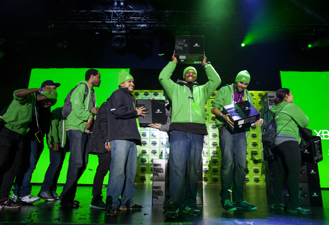 Several of the first 10 people to purchase the Microsoft Xbox One game system exalt in the moment as they receive their console at an event in New York on Friday.   AP-Yonhap News