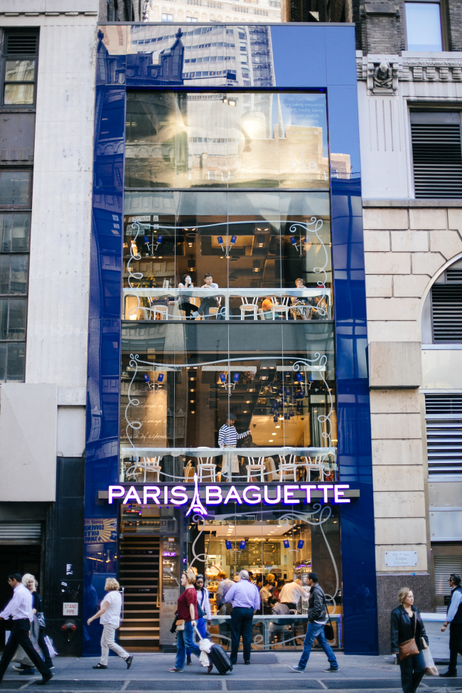 Pedestrians walk past a Paris Baguette bakery shop in Manhattan, New York.   SPC Group