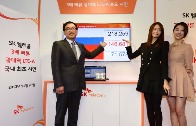 Choi Jin-sung (left), head of the ICT R&D Division of SK Telecom, Yuna from Girls’ Generation (second from left) and Sulli from f(x) attend an event to demonstrate the company’s new network technology service in Bundang, Gyeonggi Province, Thursday.   Park Hae-mook/The Korea Herald