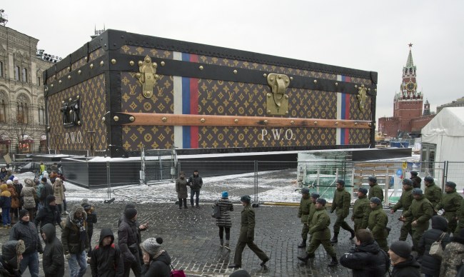 Tourists and visitors pass by a two-story Louis Vuitton suitcase erected in the Red Square in Moscow, Russia, Wednesday.   AP-Yonhap News