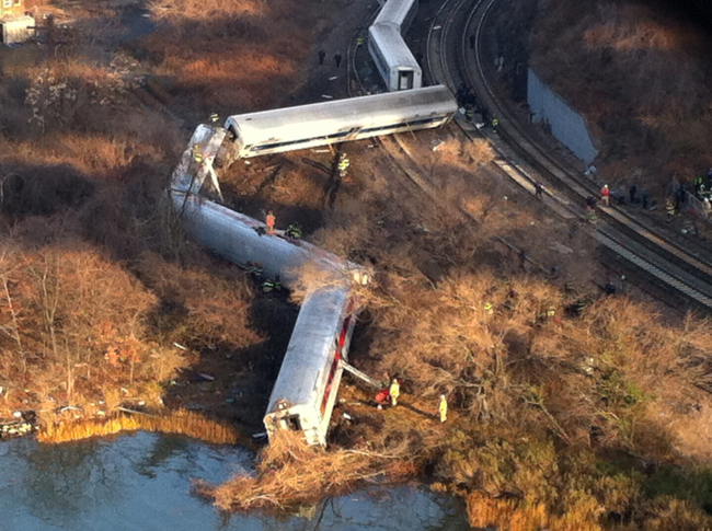 Cars from a Metro-North passenger train are scattered after the train derailed in the Bronx neighborhood of New York, Sunday, Dec. 1, 2013. The Fire Department of New York says there are "multiple injuries" in the train derailment, and 130 firefighters are on the scene. Metropolitan Transportation Authority police say the train derailed near the Spuyten Duyvil station.(AP)