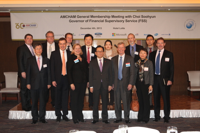 FSS Governor Choi Soo-hyun (center, front row) poses with AMCHAM members including chairman Pat Gaines (third from right, front row) after the chamber’s general meeting in Seoul, Wednesday.   FSS