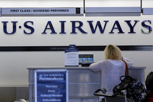 A traveler checks in for a US Airways Group Inc. flight at Los Angeles International Airport in Los Angeles, California.   Bloomberg