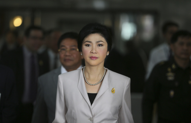 Thailand Prime Minister Yingluck Shinawatra arrives to talk to media after attending a cabinet meeting in Bangkok on Tuesday.   AP-Yonhap News