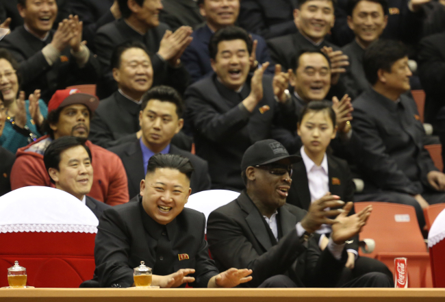 North Korean leader Kim Jong-un (left) and former NBA star Dennis Rodman watch North Korean and U.S. players in an exhibition basketball game at an arena in Pyongyang, Feb. 28.   AP-Yonhap News