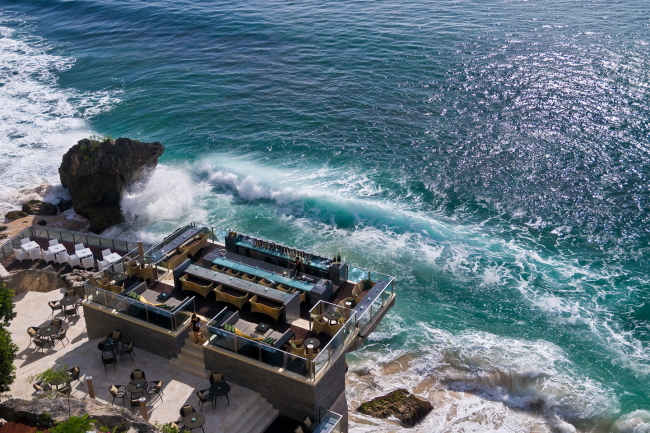 Rock Bar, an open-top bar located on natural rocks 14 meters above the Indian Ocean, is one of the iconic venues at Ayana Resort in Bali. (Ayana Resort and Spa)