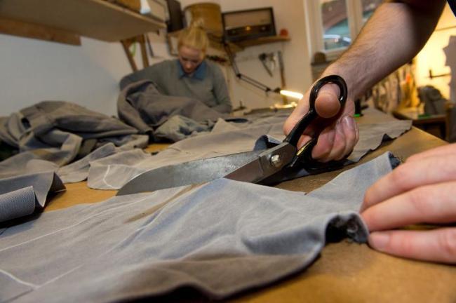 Assistants cut used clothes at German fashion designer Daniel Kroh’s workshop and showroom in Berlin.   AFP
