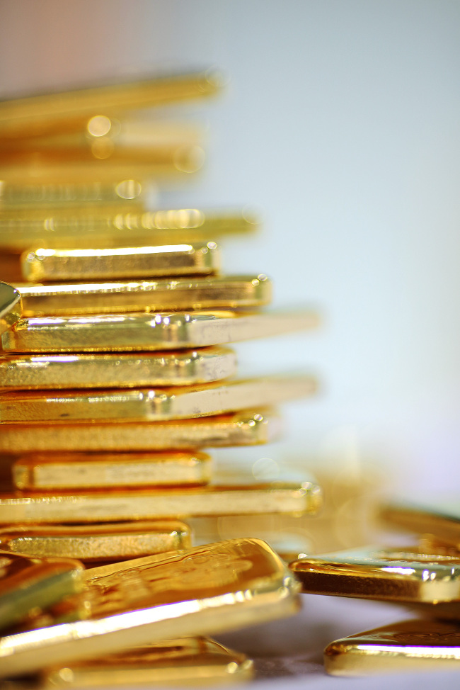 Gold bars are arranged for a photograph at the YLG Baullion International Co. headquarters in Bangkok.   Bloomberg
