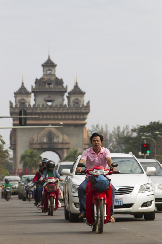 Traffic travels past the Victory Monument in Vientiane, Laos. Bloomberg