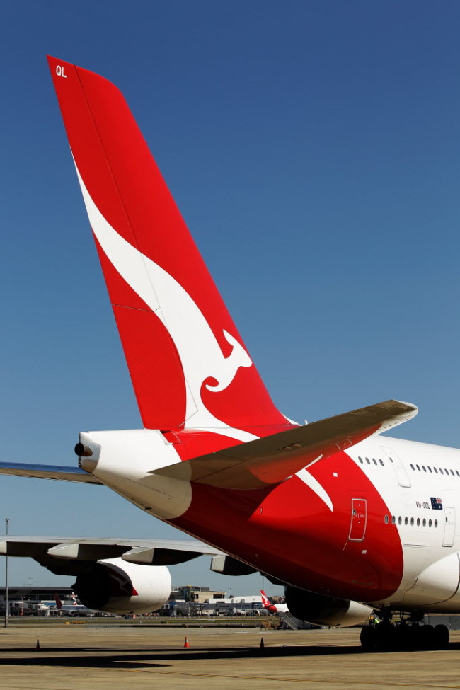 The Qantas Airways Ltd. logo is displayed on the tail of an aircraft in Sydney.   Bloomberg