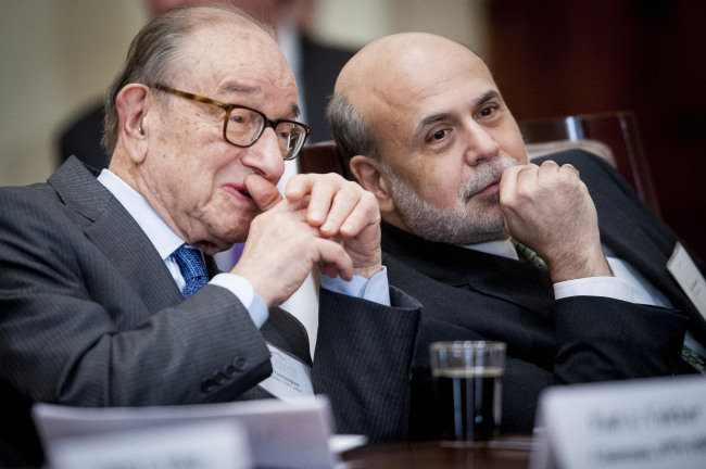 Alan Greenspan (left), former chairman of the U.S. Federal Reserve, chats with Ben Bernanke, the current Fed chairman, during an event commemorating the Federal Reserve Act, the legislation that created the central bank, in Washington on Monday.   Bloomberg