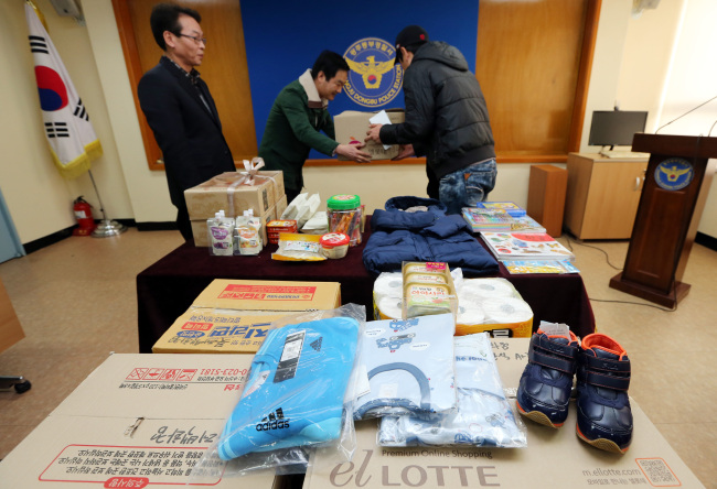 Goods that people sent to parents caught stealing to feed their baby are piled up in the Dongbu Police Station in Gwangju on Tuesday.   Yonhap News