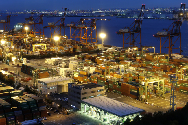 Containers are stacked at a shipping terminal in Tokyo.   Bloomberg