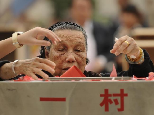 An elderly resident of Wukan casts her vote during village elections, in southern Guangdong province, China.   AFP