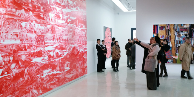 Visitors look at artwork at Hakgojae Gallery in Shanghai. Yonhap News