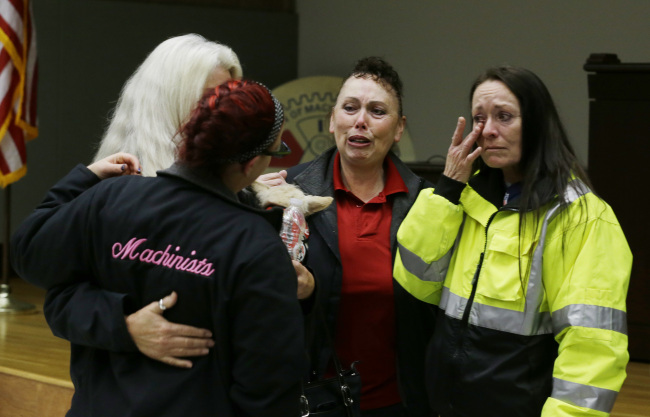 Boeing workers cry after learning that voters in District 751 of the Boeing machinists union voted to accept Boeing’s latest contract offer to keep the assembly of the Boeing 777X airplane in Seattle on Friday.   AP-Yonhahp News