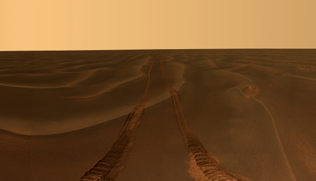 This image provided by NASA, shows rover tracks disappearing toward the horizon in a sea of sand between the craters Endurance and Victoria on the Meridiani Plains.   AP-Yonhap News