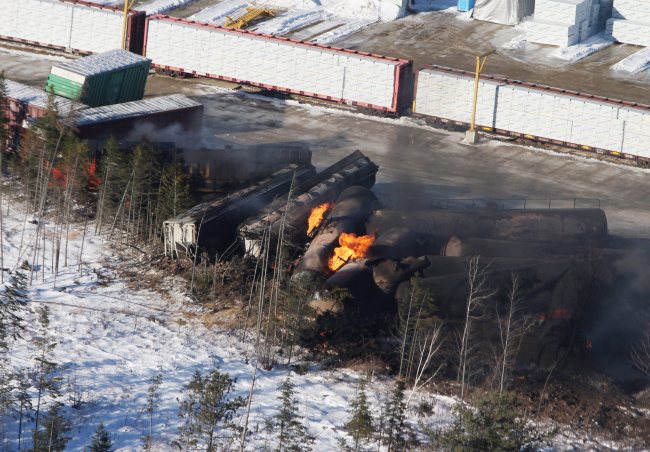 This aerial photo shows derailed train cars burning in Plaster Rock, New Brunswick, Canada, Wednesday.   AP-Yonhap News