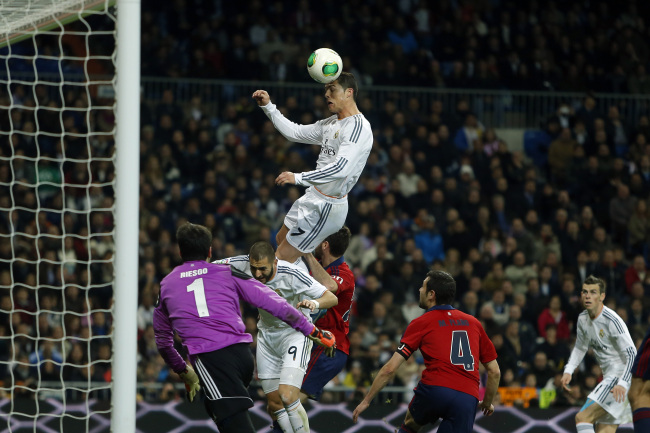 Real Madrid’s Cristiano Ronaldo jumps to head the ball during a Spanish Copa del Rey soccer match between Real Madrid and Osasuna at the Santiago Bernabeu stadium in Madrid on Thursday.   AP-Yonhap News