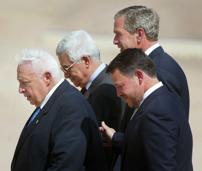 This June 4, 2003, file photo shows (from left) Israeli Prime Minister Ariel Sharon, Palestinian Prime Minister Mahmoud Abbas, King Abdullah of Jordan and U.S. President George W. Bush, walking off stage after making statements after their meeting at Beit al Bahar Palace in Aqaba, Jordan.   AP-Yonhap News