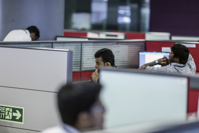 Employees work at their desks in the Tata Consultancy Services Ltd. campus in the State Industries Promotion Corporation of Tamil Nadu Ltd. (SIPCOT) IT Park in the Siruseri area of Chennai, India.   Bloomberg