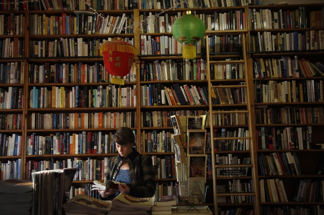 Megan Sallabedra browses at Libros Schmibros bookstore in Los Angeles on Jan. 9. The store has a Spanish-language section, which the owner says has a big demand.   Rick Loomis/Los Angeles Times/MCT