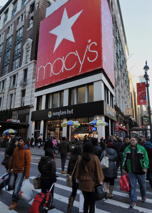 Pedestrians walk past Macy’s Inc. flagship store in New York.   Bloomberg