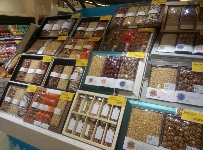 Various holiday gift boxes are lined up on a shelf at Shinsegae Department Store in Seoul on Friday.   Suk Gee-hyun/The Korea Herald