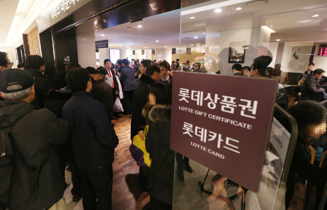 Customers wait to have their credit cards reissued to prevent losses from a leak of personal information at the Lotte Card Center in a branch of Lotte Department Store in Seoul on Monday.   Yonhap News