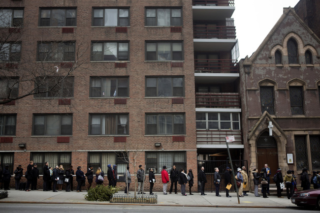 Job seekers wait in line to enter a job fair in New York.   Bloomberg