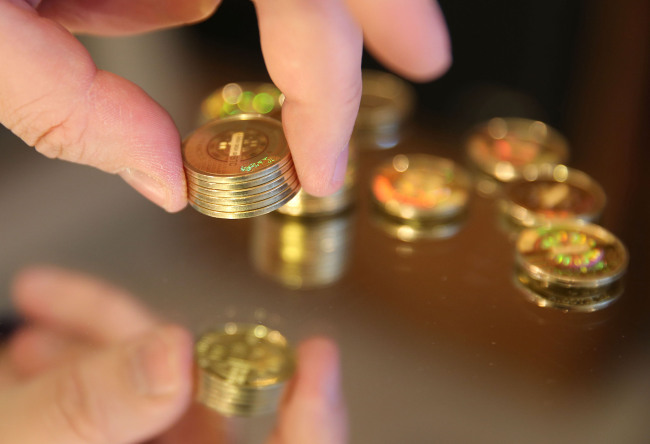 A man stacks Bitcoins in Sandy, Utah.   Bloomberg