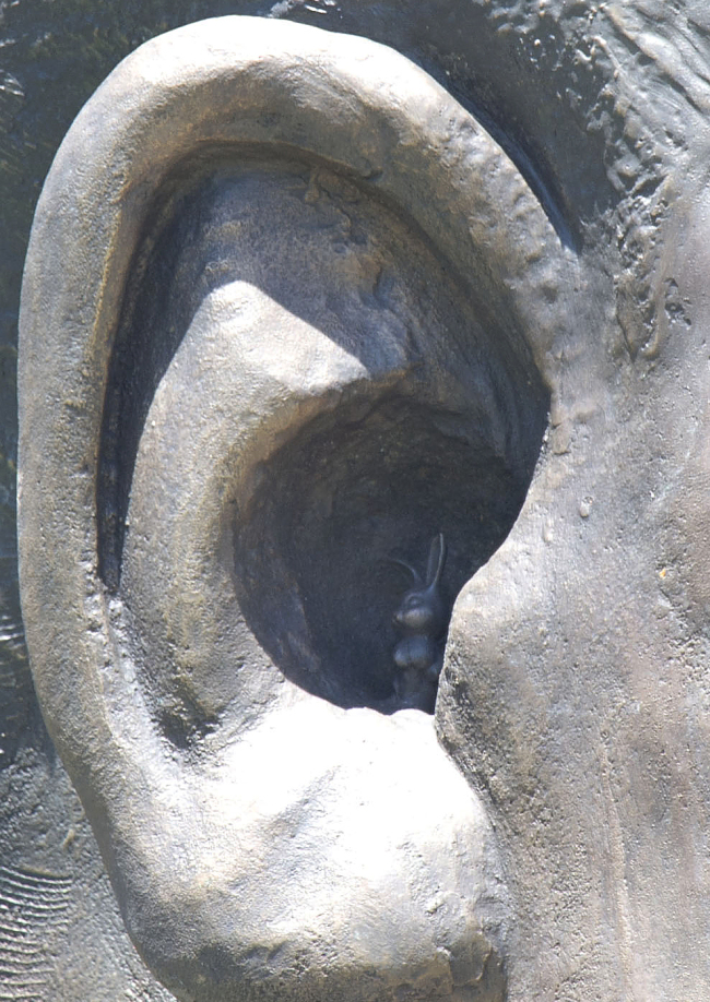 A sculpture of Nelson Mandela, with a barely visible sculpted rabbit tucked inside one of the bronze ears.   AP-Yonhap News