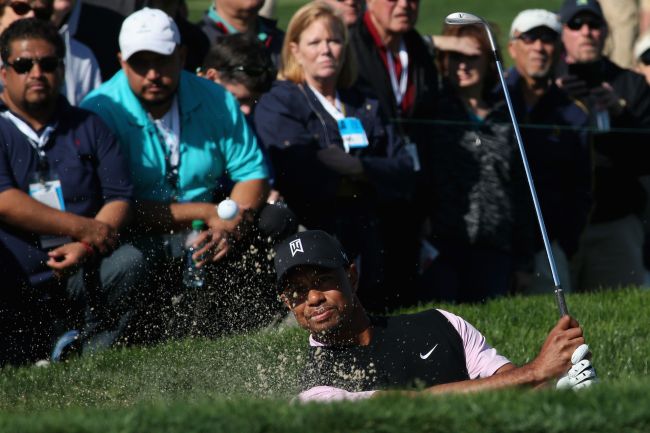 Tiger Woods hits a shot out of a bunker on the fifth hole during the first round of the Farmers Insurance Open on Torrey Pines South in La Jolla, California, Thursday.   AFP-Yonhap