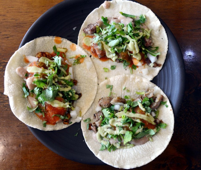 (Clockwise from top) Paco Loco’s carne asada, tripas de res and camarones a la diabla tacos come draped in tomatillo-avocado salsa and salsa roja. (Kim Myung-sub/The Korea Herald)